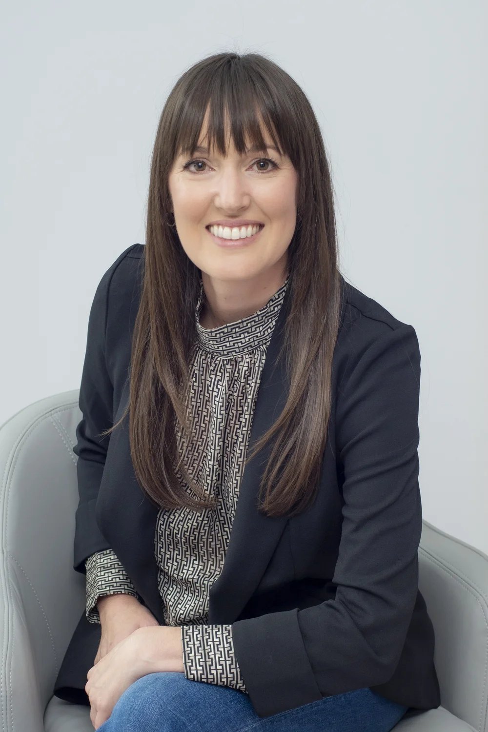 Chantal Benoit seated, smiling — bilingual real estate agent in Rockland, Ontario
